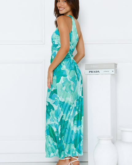Side profile of the women's blue and green floral one shoulder pleated maxi dress, highlighting the fitted bodice and flowing skirt.