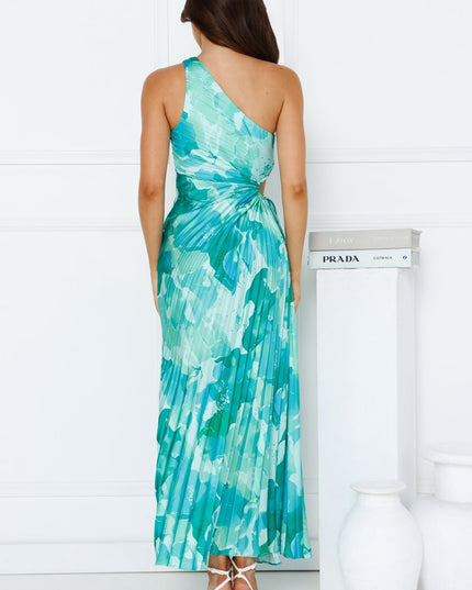 Back view of the women's one shoulder cutout maxi dress in a striking blue and green floral print with a pleated skirt.
