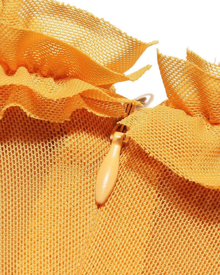 Close-up of the yellow mesh fabric and ruffled detail on the women's prom dress, showing zipper.