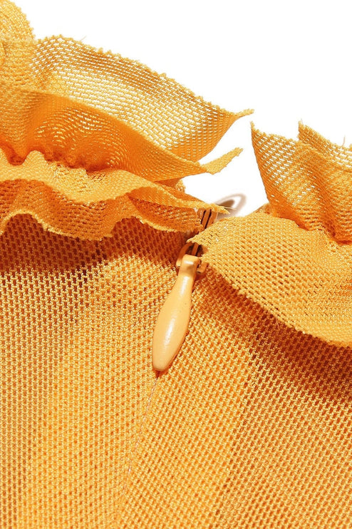 Close-up of the yellow mesh fabric and ruffled detail on the women's prom dress, showing zipper.