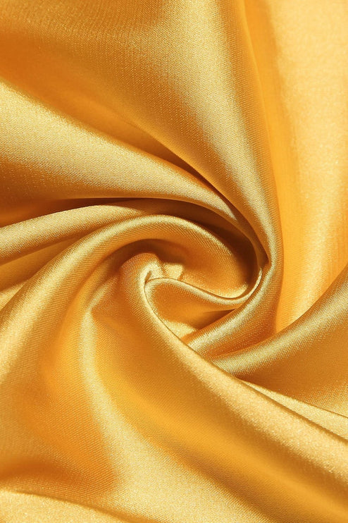 Textured close-up of the lustrous yellow satin fabric, suitable for a women's prom dress.