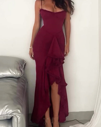 Women's long burgundy evening dress featuring a ruffled front, spaghetti straps, and a ruched design.