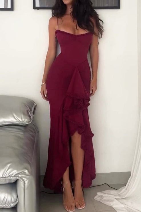 Women's long burgundy evening dress featuring a ruffled front, spaghetti straps, and a ruched design.