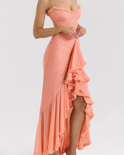 Side profile of a peach women's prom ruffled front maxi dress, showcasing the high-low hem and ruched fabric.
