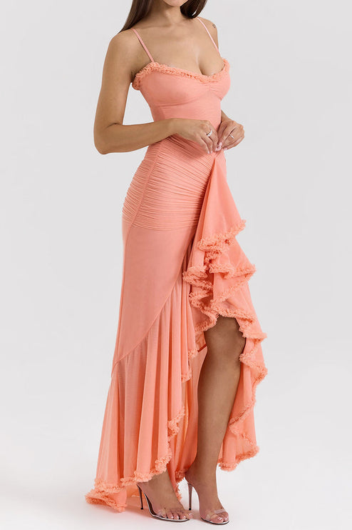 Side profile of a peach women's prom ruffled front maxi dress, showcasing the high-low hem and ruched fabric.