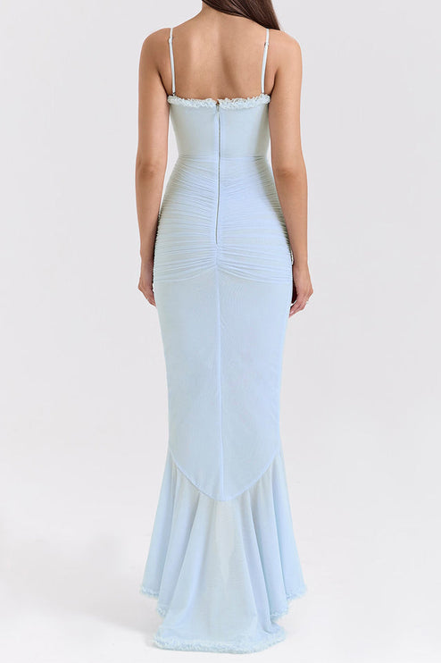 Back view of a women's light blue prom dress with spaghetti straps, ruched detailing, and a flowing ruffled hem.