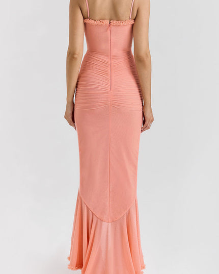 Back view of a peach women's prom ruffled maxi dress, highlighting the fitted silhouette and subtle train.