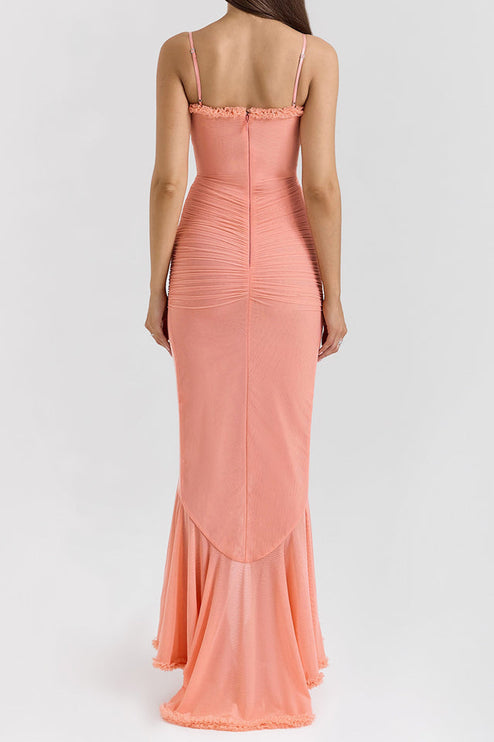 Back view of a peach women's prom ruffled maxi dress, highlighting the fitted silhouette and subtle train.