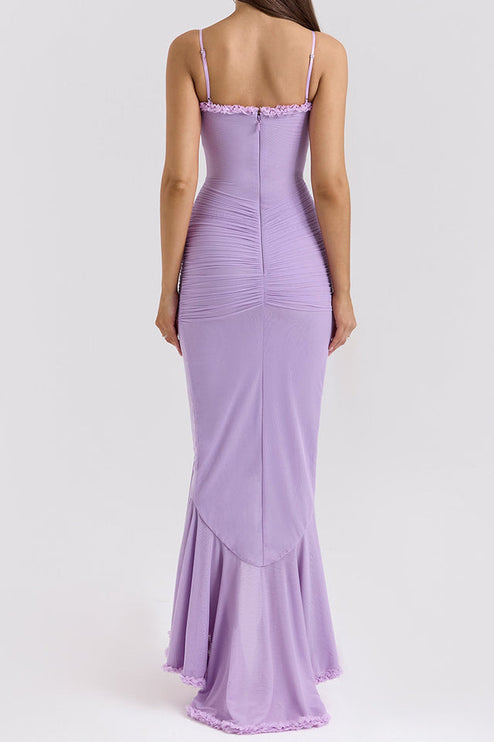 Back view of a light purple maxi dress with ruched detailing on the bodice and a ruffled hemline.