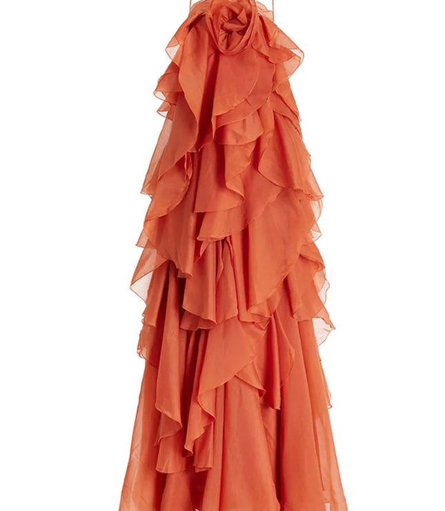 Full product shot of a coral strapless ruffle layered maxi dress, featuring delicate spaghetti straps and an intricate floral bust detail, for prom.