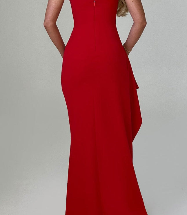 Back view of a red V-neck maxi dress with thin straps, featuring a subtle side ruffle detail.