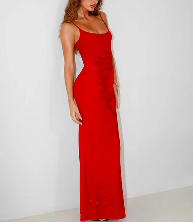 Angled view of the red embellished scoop neck maxi dress, emphasizing the fitted waist and flowing skirt.