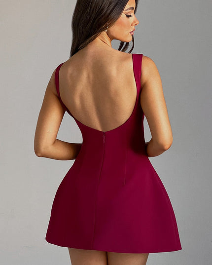 Side-back view of the red bubble mini dress, featuring the scoop back and short hemline.