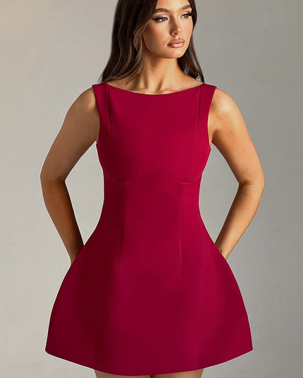 Front view of a women's red high neck bubble mini dress with a fitted bodice and flared skirt, hands in pockets.