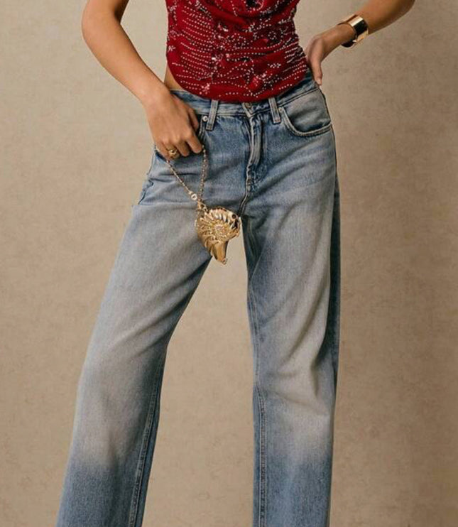 Full body shot of a women's red sequin halter deep V neck top, paired with wide-leg light wash jeans and heels.