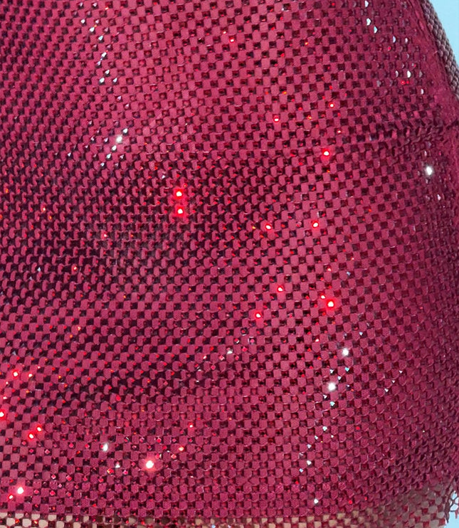 Close-up detail of the red rhinestone fabric on the women's mini dress, showing the intricate mesh and individual sparkling stones.