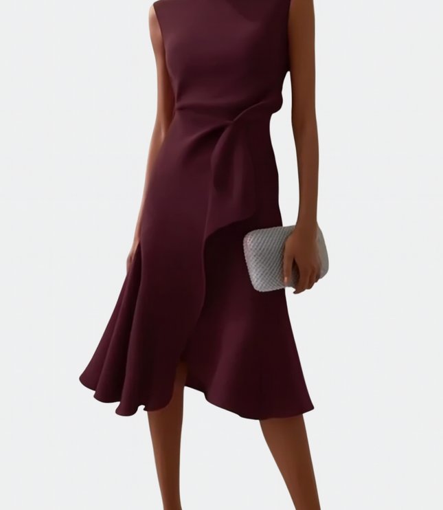 Front view of a women's sleeveless burgundy midi dress, featuring an elegant draped asymmetric hemline and a silver clutch.