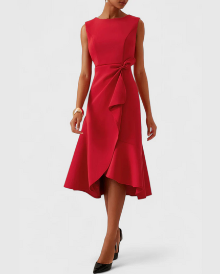 Full front view of a women's vibrant red sleeveless draped asymmetric midi dress, styled with black heels.