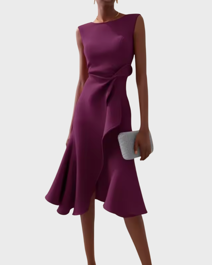 Deep plum sleeveless midi dress featuring a graceful draped asymmetric style, complete with a waist ruffle and a flared skirt.