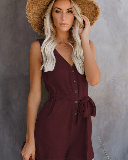 Front view of a women's sleeveless V-neck romper in deep burgundy with a tie waist and visible buttons.