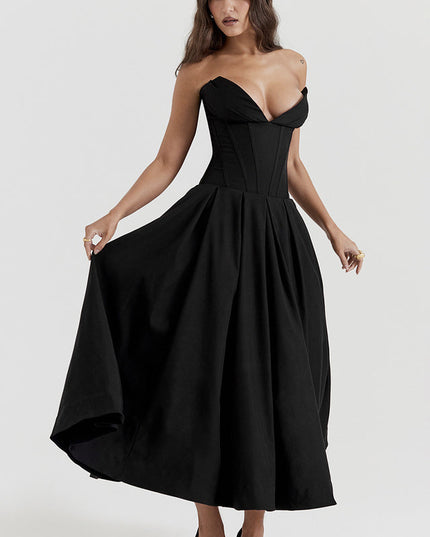 Women's black strapless midi dress with boned bodice and full pleated skirt, hands on skirt.