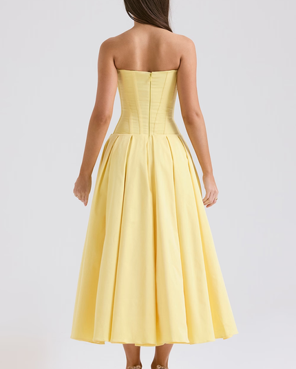Back view of a yellow strapless boned bodice pleated midi dress, highlighting the corset details and zipper closure.