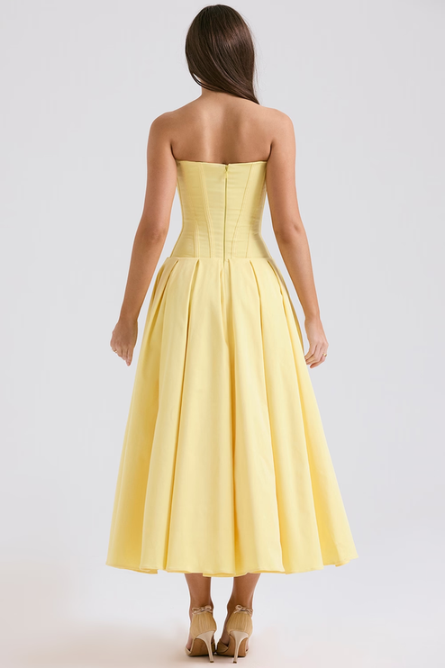Back view of a yellow strapless boned bodice pleated midi dress, highlighting the corset details and zipper closure.