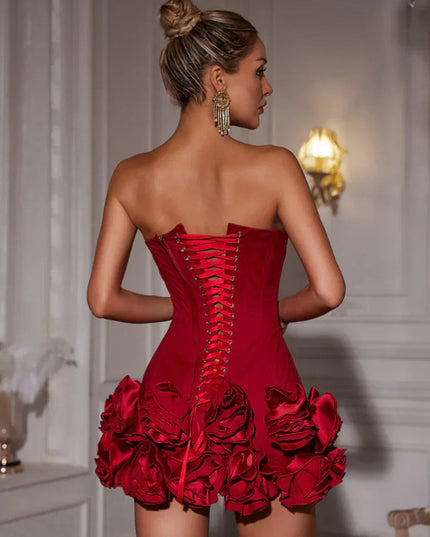 Close-up back view of a red strapless corset mini dress, highlighting the intricate lace-up design.