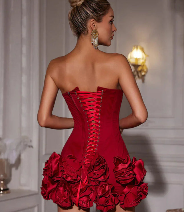 Close-up back view of a red strapless corset mini dress, highlighting the intricate lace-up design.