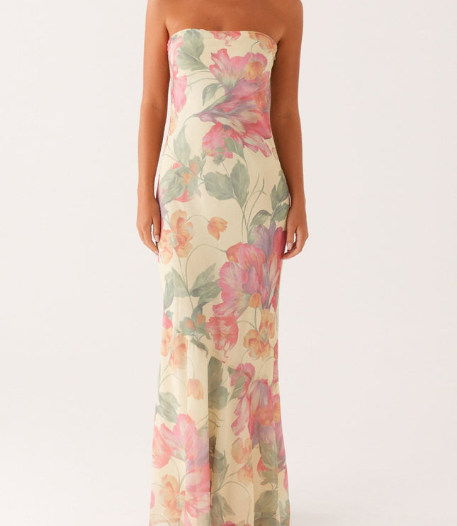 Front view of women's strapless floral maxi dress in a light yellow hue with vibrant pink and green floral patterns.