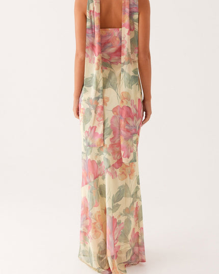 Back view of the women's strapless floral maxi dress, highlighting the long, draped scarf detail and form-fitting silhouette.