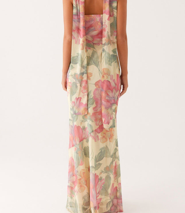 Back view of the women's strapless floral maxi dress, highlighting the long, draped scarf detail and form-fitting silhouette.