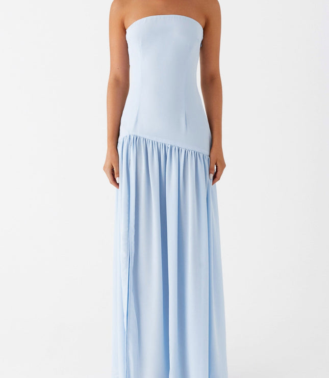 Front view of a light blue strapless maxi dress with a ruffled hemline and elegant drape.