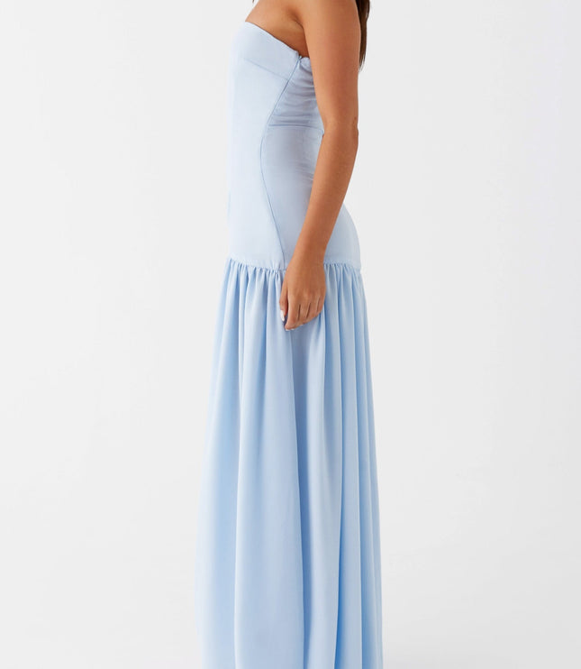 Side profile of a light blue strapless maxi dress, highlighting the tailored fit and long skirt.