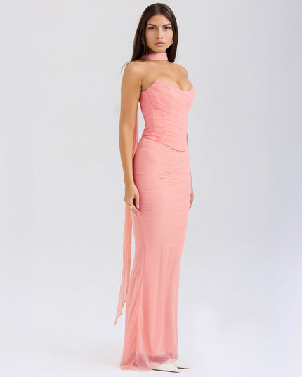 Side profile of the pink strapless mesh ruched maxi dress, showing the flowing skirt and fitted bodice.