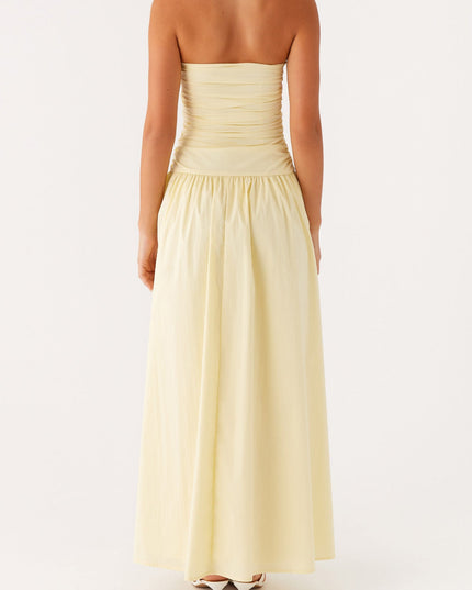 Back view of the women's light yellow strapless maxi dress, showing the ruched bodice detail.