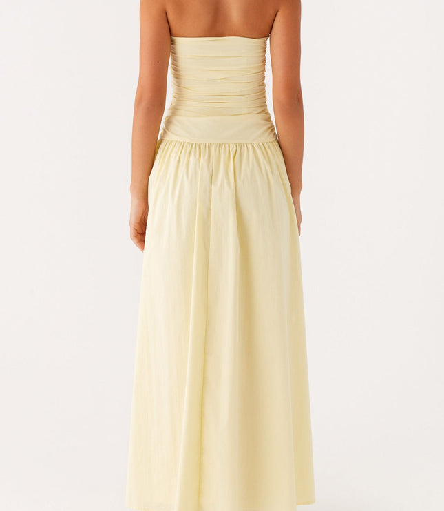 Back view of the women's light yellow strapless maxi dress, showing the ruched bodice detail.