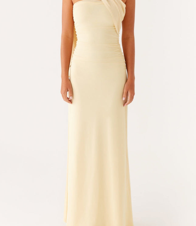 Front view of a women's pale yellow strapless maxi dress with a draped neck scarf and ruched bodice.