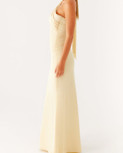 Side profile of a women's elegant pale yellow strapless maxi dress with a flowing neck scarf detail.