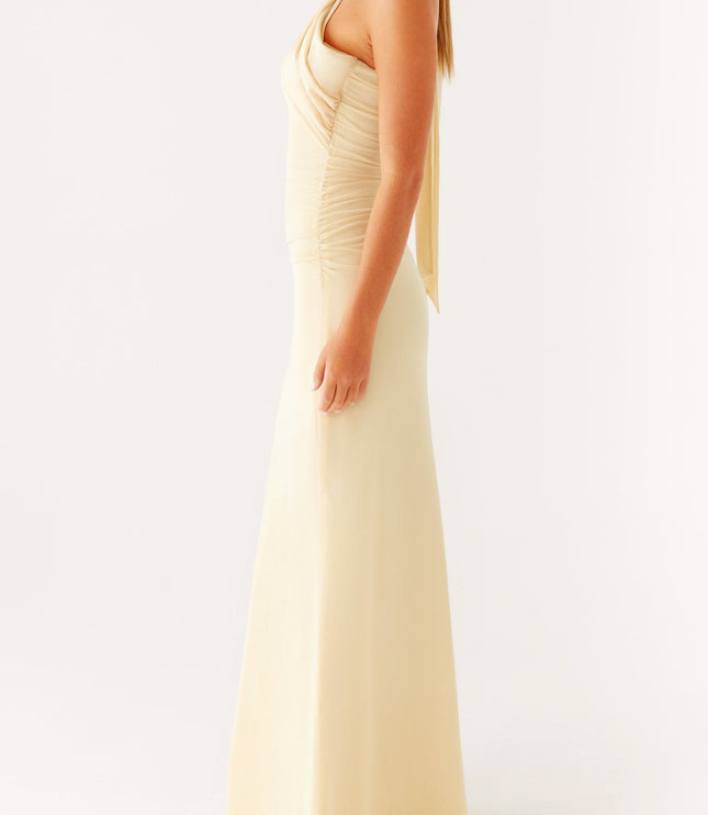Side profile of a women's elegant pale yellow strapless maxi dress with a flowing neck scarf detail.