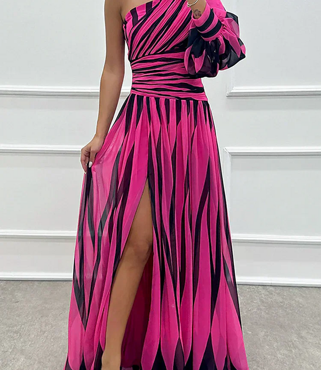 Pink and black striped one-shoulder maxi dress with a single long sleeve and thigh-high slit detail