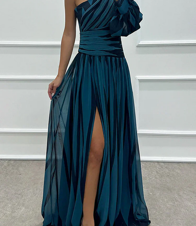 Teal and black striped one-shoulder maxi dress with a flowy skirt, high slit, and ruched bodice