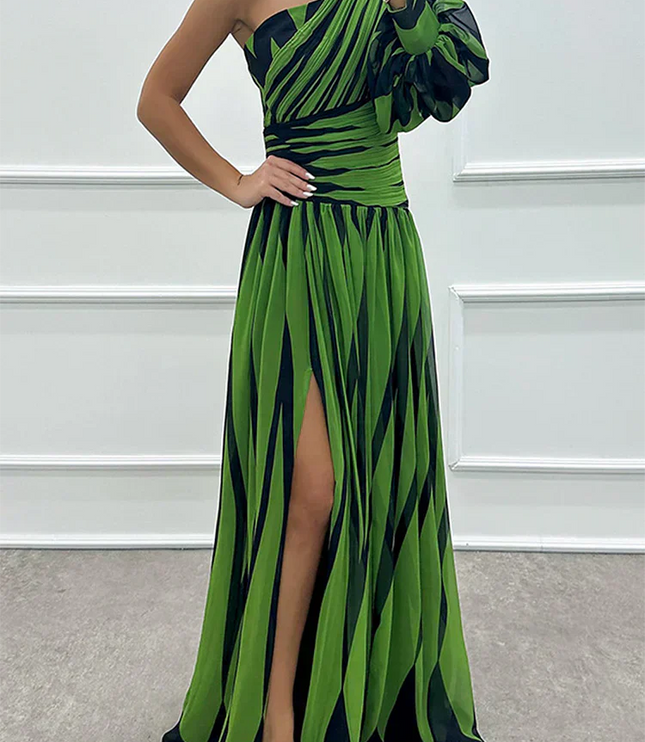 Women's green and black striped one-shoulder maxi dress, showcasing the high slit and puff sleeve
