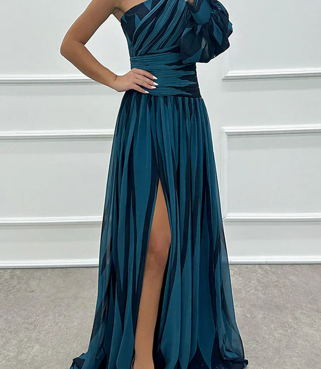 Women's teal and black striped one-shoulder maxi dress, highlighting the high slit and elegant design