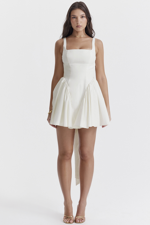 Front view of a white square neck mini dress with a gathered skirt and long back ties, for summer.