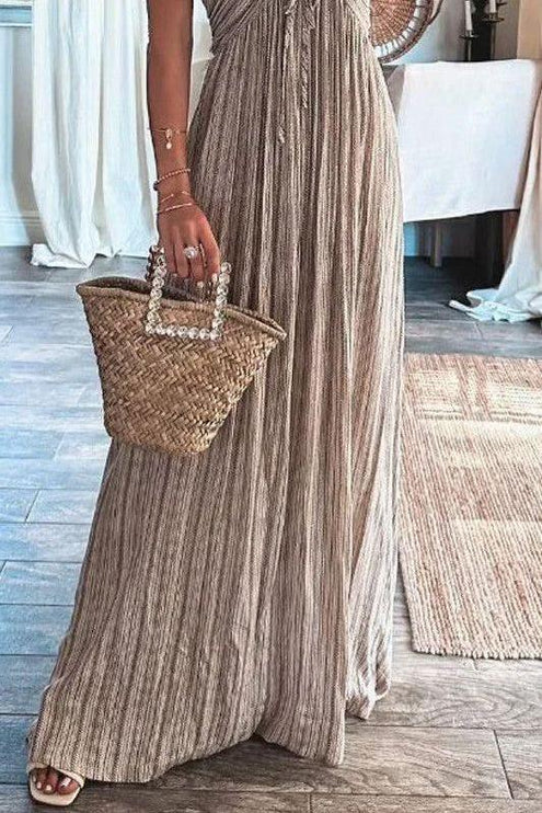 Close-up of the lower half of the women's striped maxi dress, highlighting the flowing skirt and vertical stripes.