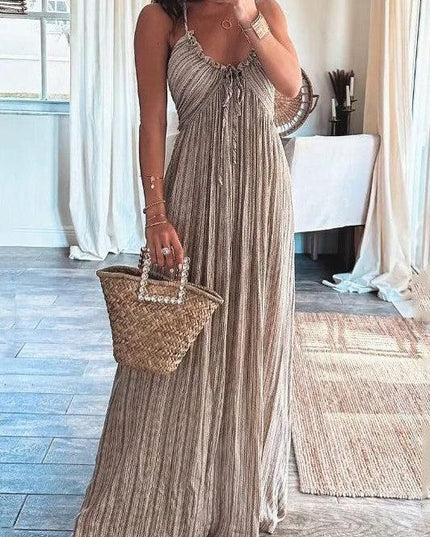 Full-length view of a women's summer backless striped maxi dress in beige with U-neck and tie detail.