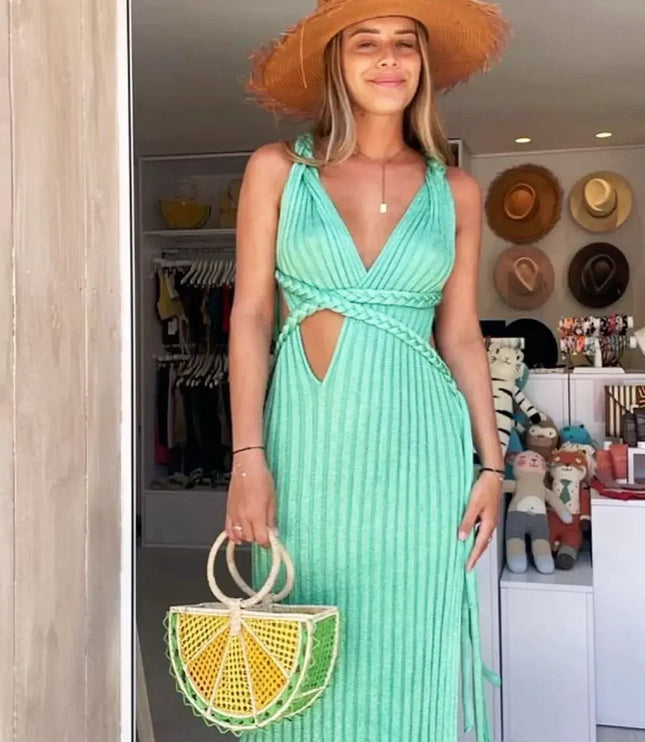 Women's mint green V-neck braided maxi dress with a straw hat and lemon-shaped handbag.