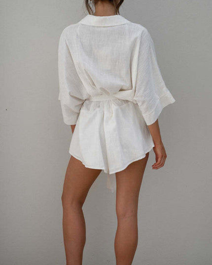 Full back view of a women's white summer collared short romper, showcasing the fabric texture and tied waist.