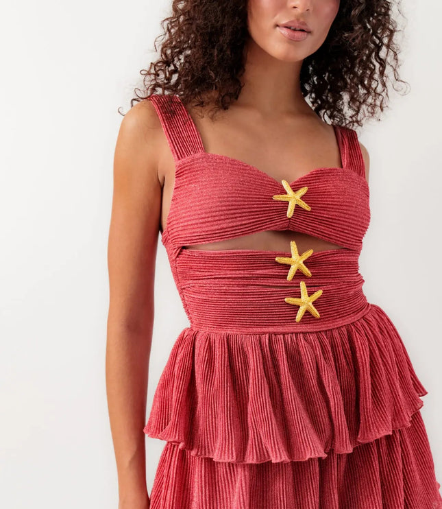 Close-up of women's coral summer mini dress with cut-outs and three gold starfish embellishments.